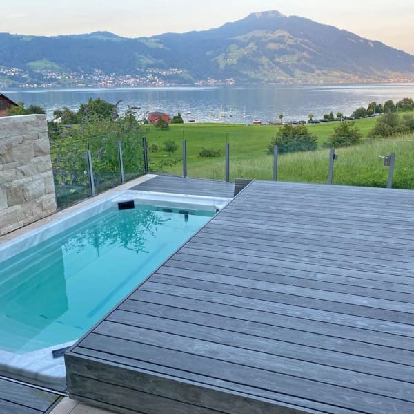 Grey Accoya decking around a small pool overlooking a lake