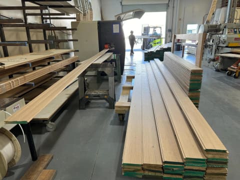 Racks and carts of milled boards in the Revival Millworks shop
