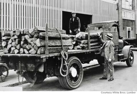 A White Brothers lumber truck loaded with logs, around 1920