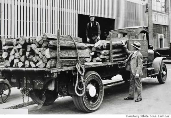 A White Brothers lumber truck loaded with logs, around 1920