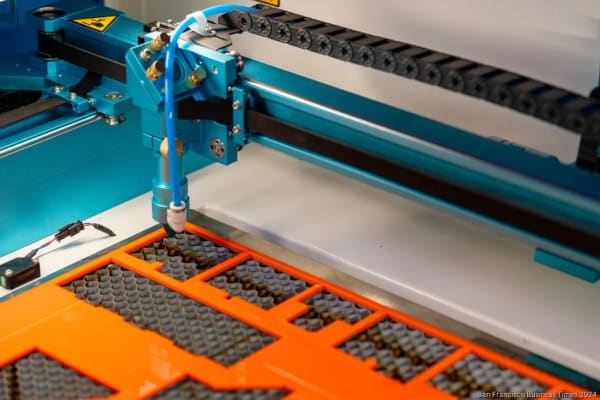 A laser cutting moulding knife templates on the shop's cutting bed