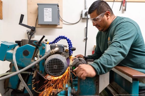 A Revival Millworks machinist grinding a new moulding knife