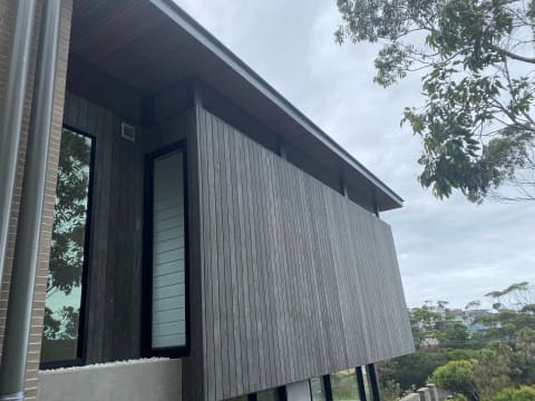 A house clad in grey-weathered Accoya siding
