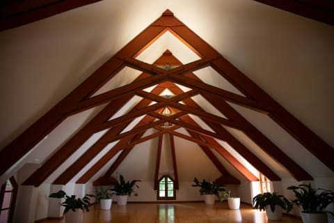 Exposed heavy timber trusses under a pitched roof